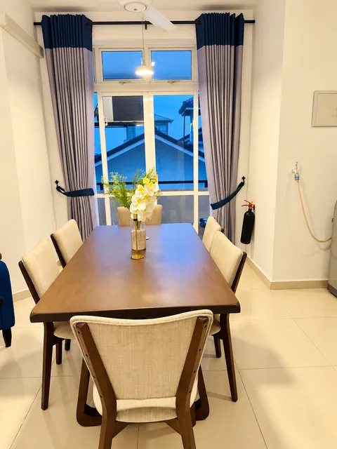 Dining table beside the apartment balcony doors